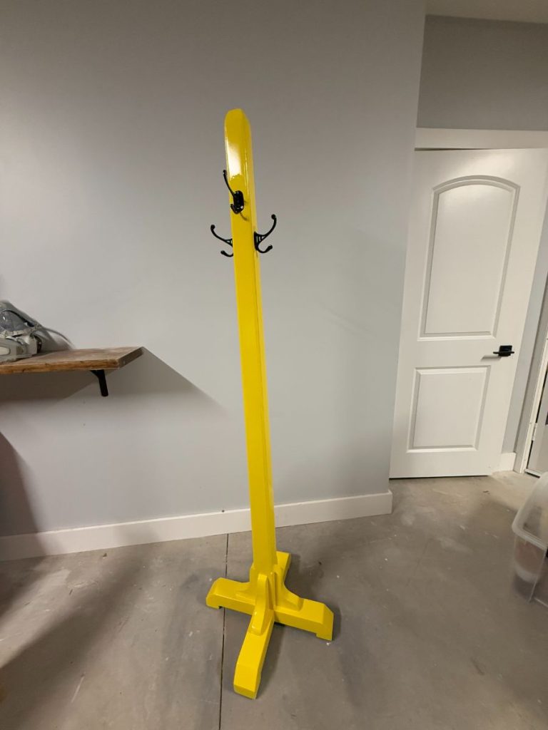Custom refinished wooden coat rack tree painted in a vibrant bright yellow finish, by Simons Painting & Drywall
