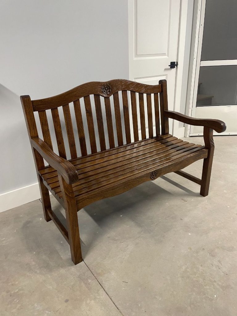 Restored wooden bench with a rich dark wood stain and protective topcoat.