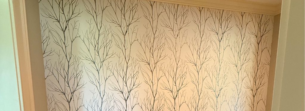 Dark navy coastal octopus-patterned wallpaper installed above white horizontal shiplap trim by Simons Painting & Drywall