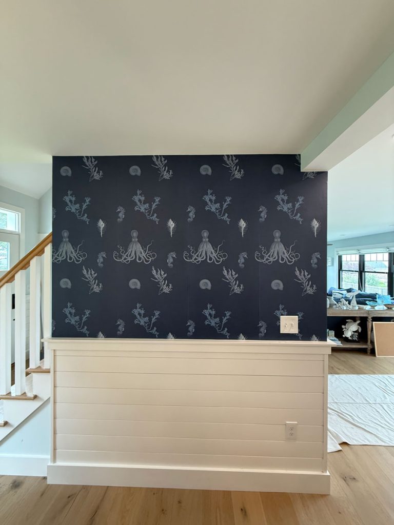 Custom coastal wallpaper installation on an accent wall by Simons Painting & Drywall